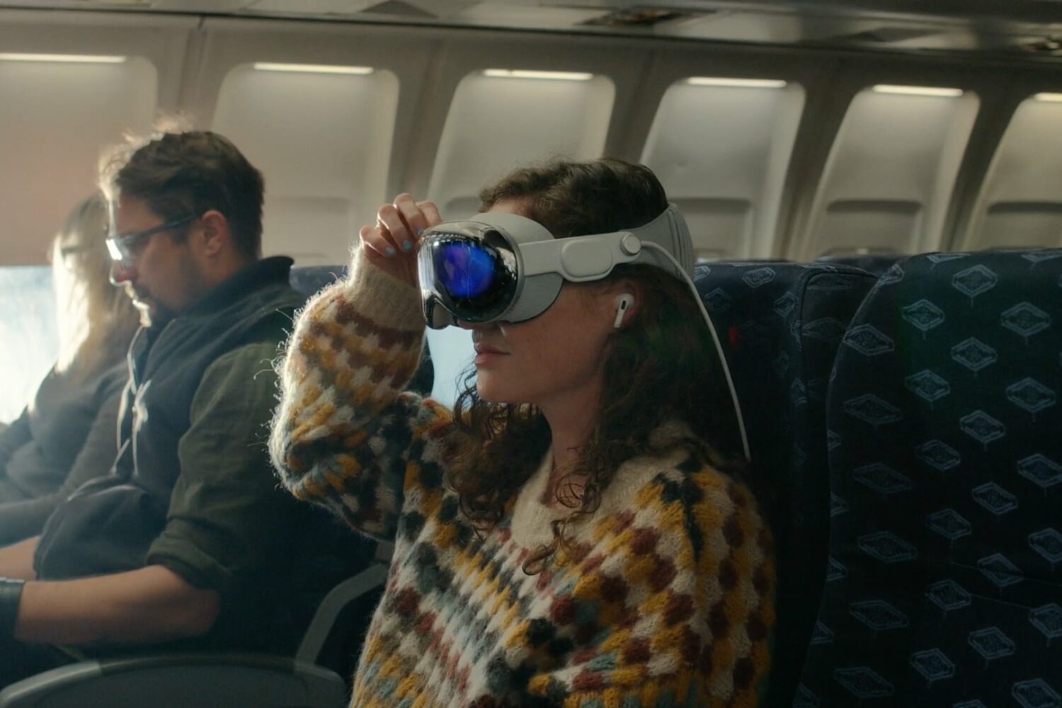 Woman on an airplane watching movies using the Vision Pro headset