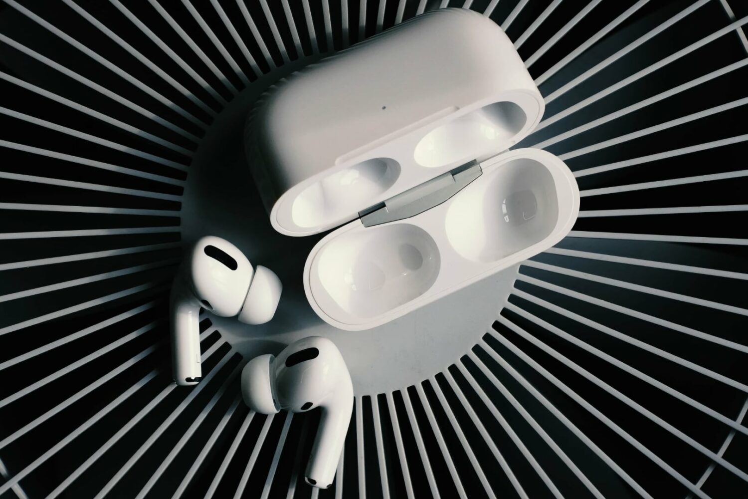 AirPods Pro outside their charging case with the lid open