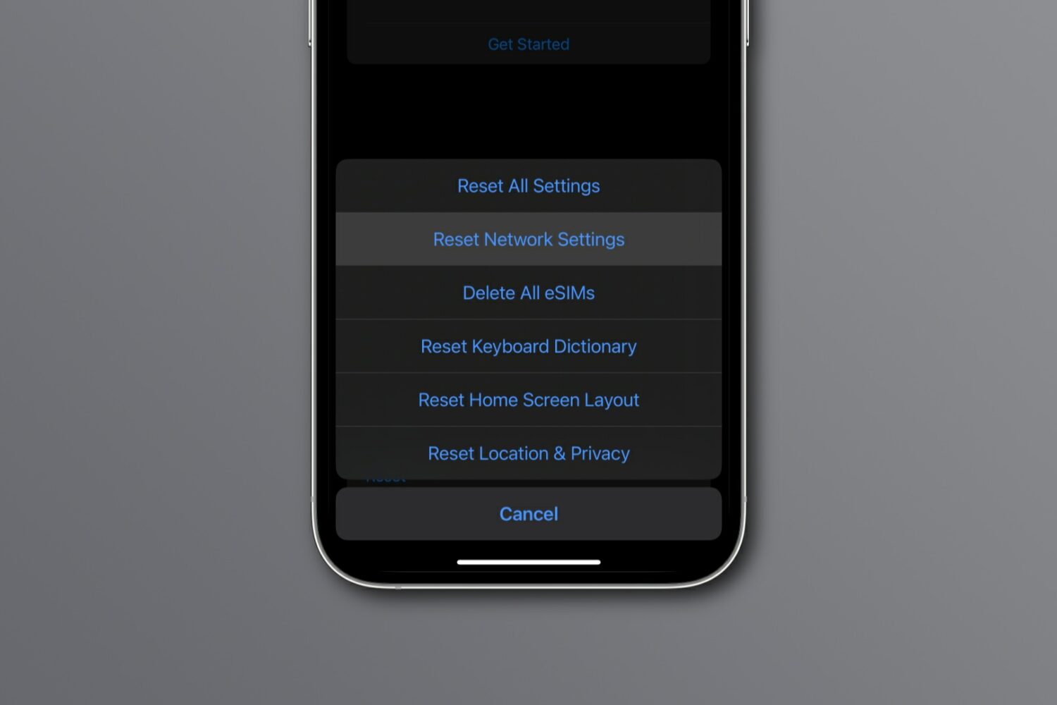 The Reset Network Settings option highlighted in the iPhone's Settings app