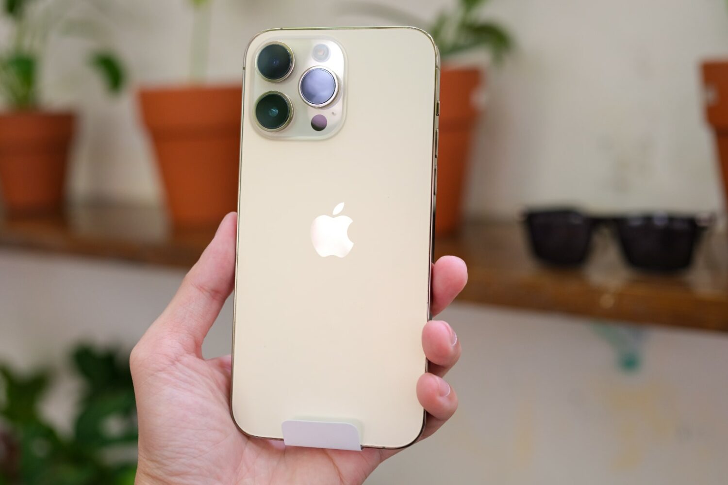 Gold iPhone 14 Pro Max in hand