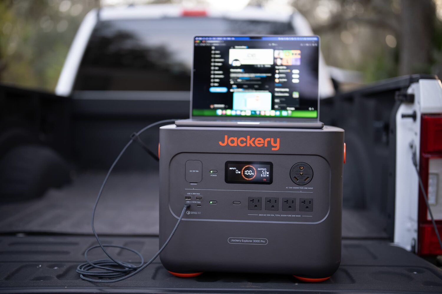 Jackery 3000 Pro charging MacBook Pro outdoors.