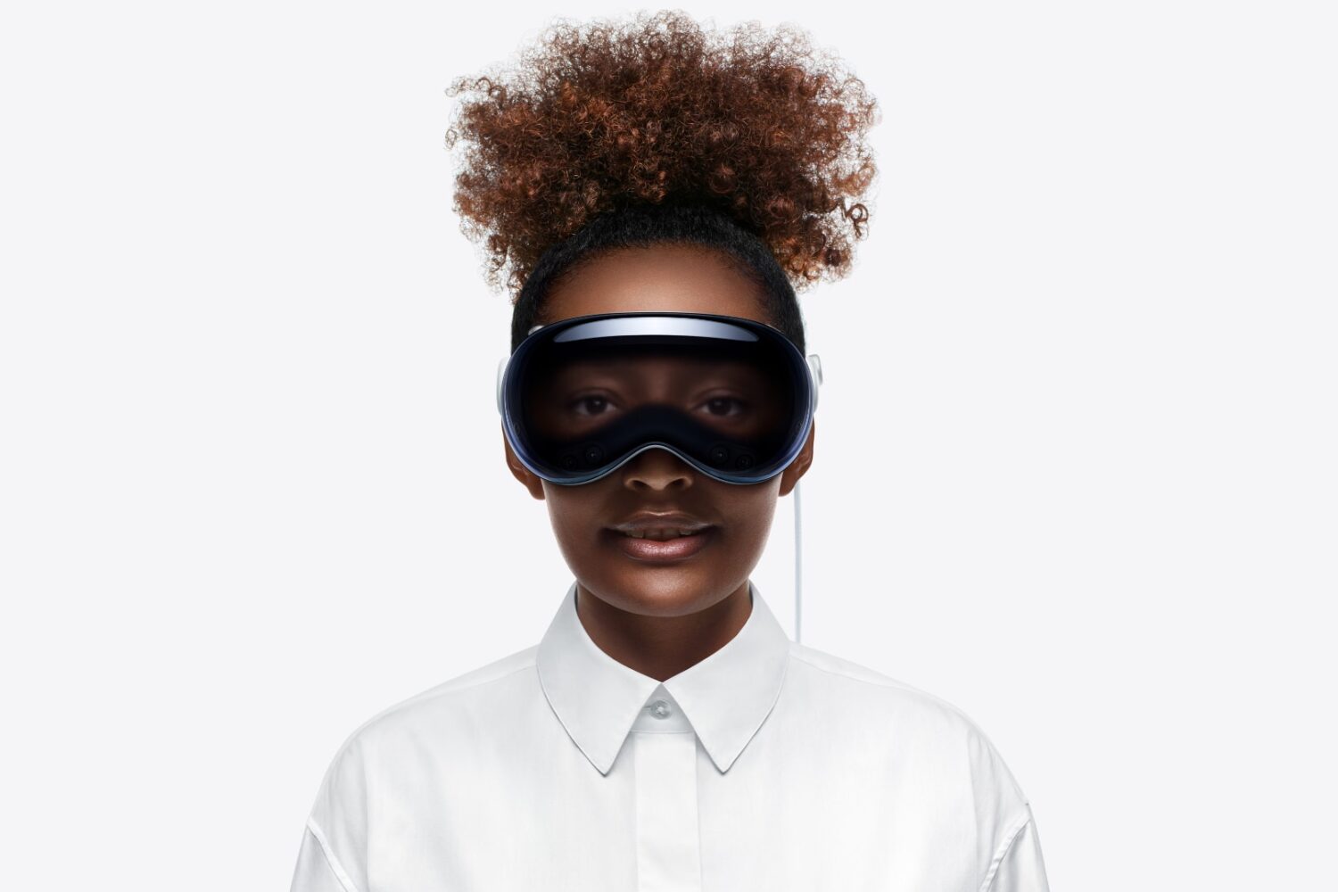 Woman wearing Apple Vision Pro headset, with EyeSight displaying her digital eyes