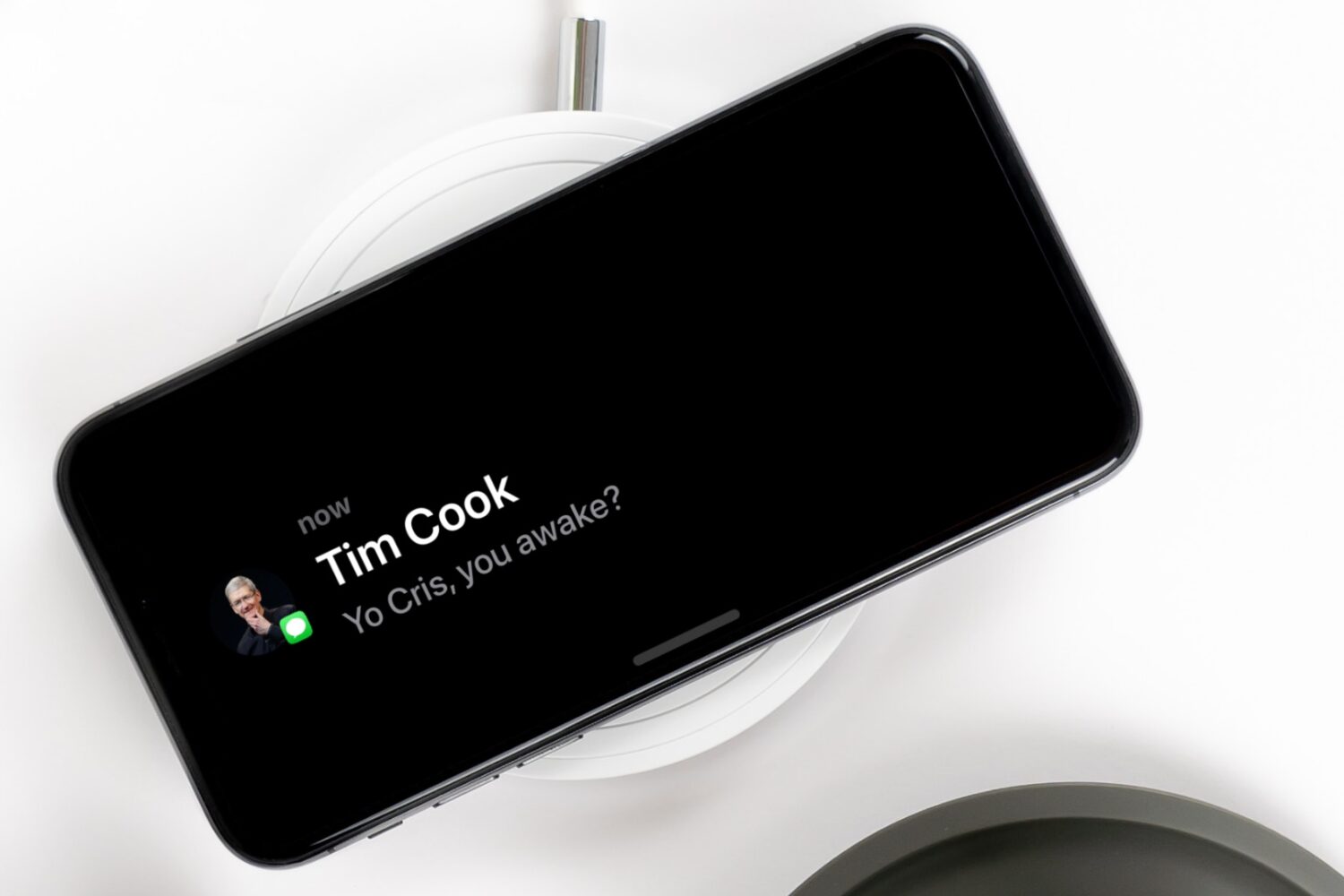 iPhone XS Max charging on a MagSafe stand, displaying a notification in StandBy Mode