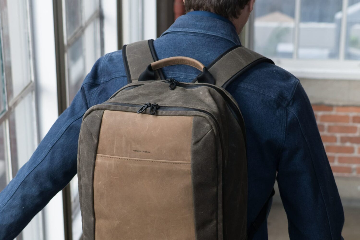 Man wearing Waterfield Designs Tech Folio Backpack