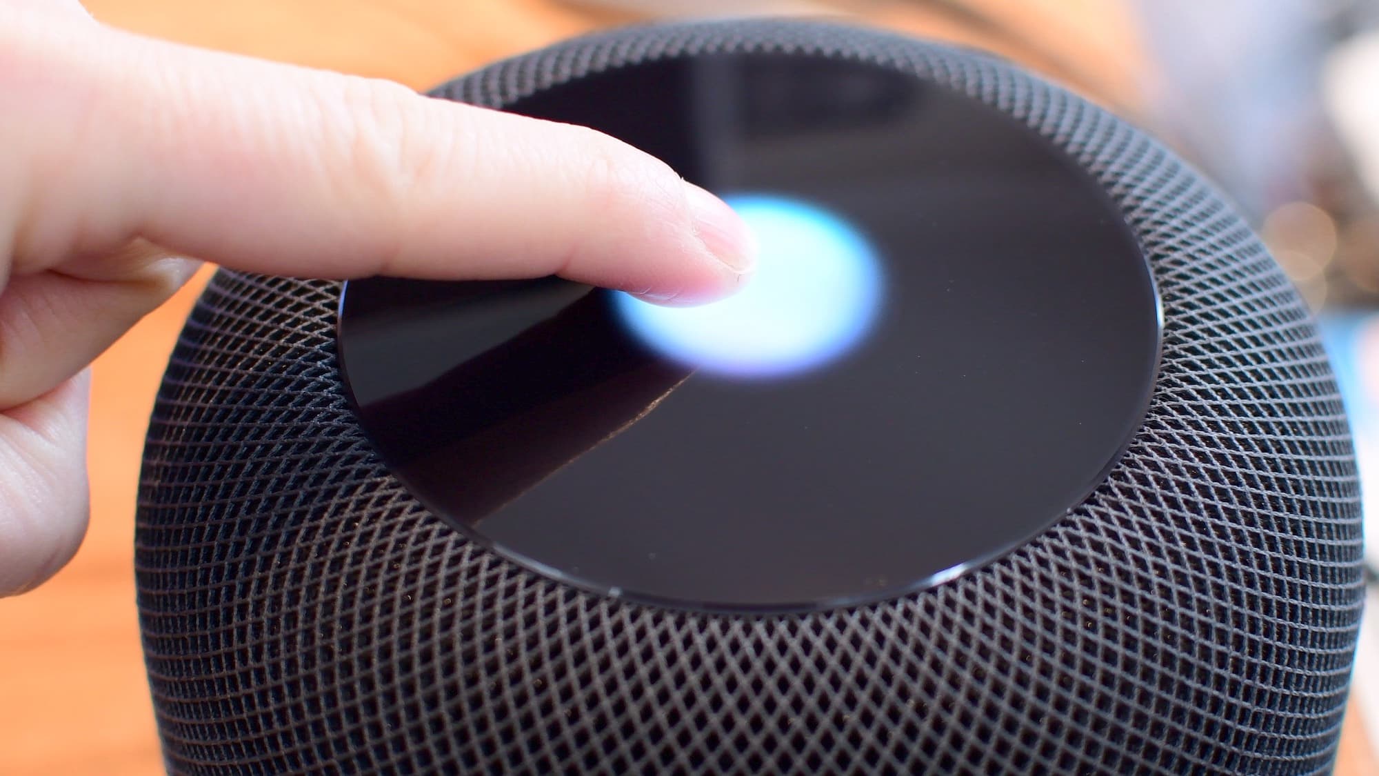 Touching the top of HomePod to control it
