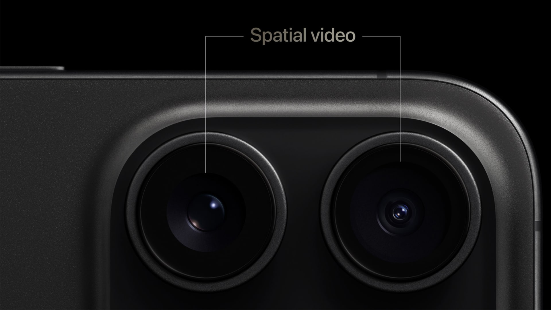 Closeup of the rear camera system on iPhone 15 Pro with the two spatial cameras highlighted
